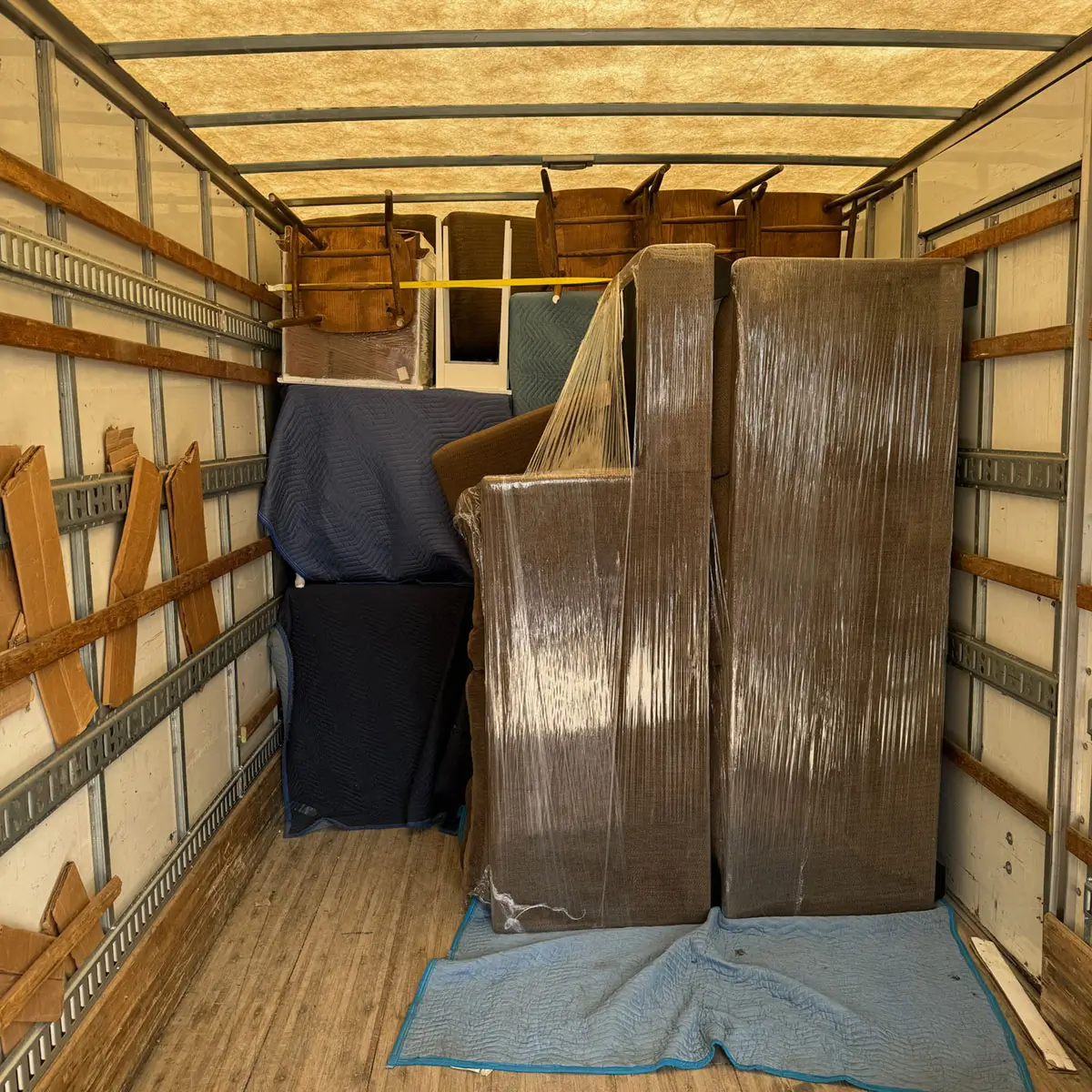 Anywhere Moving truck interior with wrapped furniture